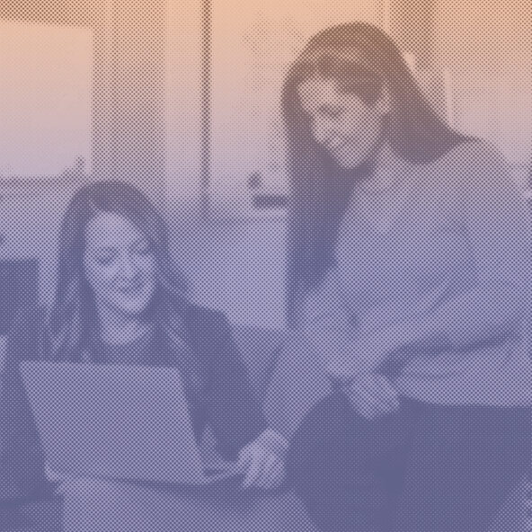 Two women looking at a laptop
